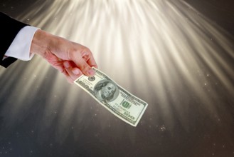 Symbolic image, hand reaches out 100-dollar note, purchasing power, stable currency, currency war,