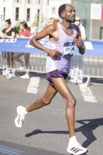 Guye Adola (ETH), later in 4th place, at KM38 in front of Potsdamer Platz at the 51st BMW Berlin