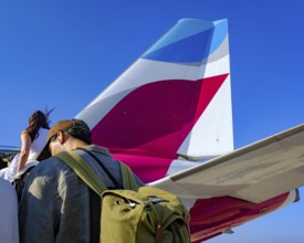 Mykonos, Greece - EUROWINGS. At Mykonos Airport, holidaymakers board a Eurowings aircraft via an