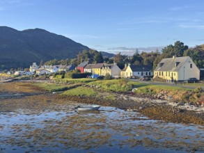 Coastal landscape with charming colourful houses and a small boat in the evening light, Dornie,