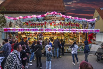 Shooting gallery in the evening at the church fair in the village of Eschenau, Middle Franconia,