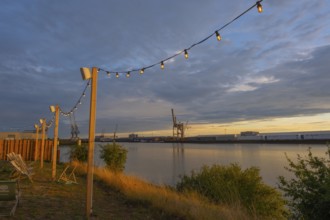 View from the outside area of a restaurant at Lankenauer Höft through a string of lights onto