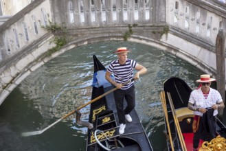 Venice, Italy - 3 September 2025: Gondolier on a gondola in Venice during the 82nd Venice