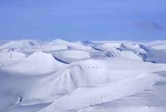 Aerial view over snow-covered mountains and valleys on Svalbard, Spitsbergen in spring, Norway