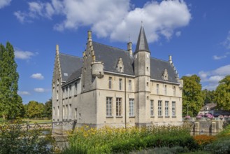 Kasteel Cortewalle, 15th century moated castle in Flemish Renaissance style at Beveren in summer,