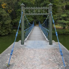 1824 iron suspension bridge in park of the Wissekerke Castle, Kasteel van Wissenkerke in the