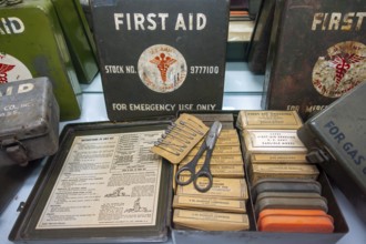 WW2 American first aid kits showing bandages, dressings and safety pins in metal boxes of the US