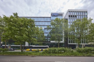 Auditing and management consultancy KPMG, modern architecture, street, public bus, trees, milky