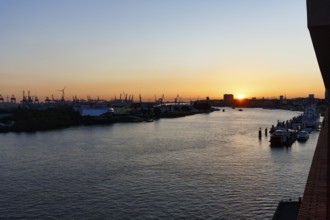 Hamburg harbour, view from the Elbphilharmonie over the Elbe at sunset, cranes of the container