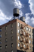 Residential tower with wooden water tanks on the roof, New York City, USA