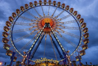 Dark clouds behind the illuminated Ferris wheel, Festwiese, Theresienwiese, Oktoberfest, Munich,