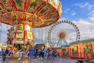 Chain carousel at a standstill, Ferris wheel in the background, Theresienwiese, Oktoberfest,