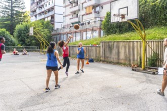 Female basketball player jumping and shooting the ball during a training session on an outdoor