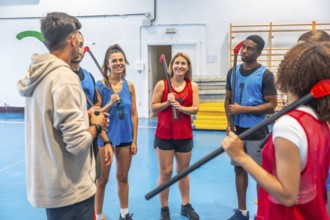 Multi ethnic team players actively listening to their coach as they receive instructions during a