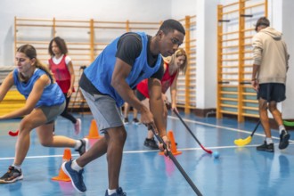 Floorball players sprinting between cones while honing their stick handling skills during a vibrant