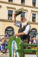 A traditional costumer on a carriage greets the spectators, Trachten- und Schützenzug, Oktoberfest,