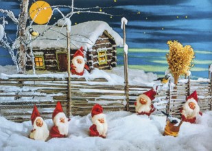 Old Christmas greeting card. Elves in snow in front of a fenced yard and log cabin