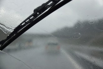 Car journey in rainy weather, summer, Germany