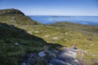 Woman with backpack standing on stone stairs, Sherpat stairs or Midsund stairs or Midsundtrappene,