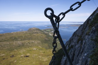 View over coastal landscape with offshore islands, silhouette, hook of a via ferrata in the