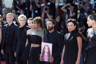 Venice, Italy - 3 September 2025: Motaz Malhees with a portrait of five-year-old Palestinian girl