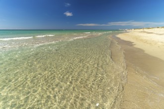 Crystal-clear turquoise water on the beach at Torre San Giovanni, Marina di Ugento, Apulia, Italy