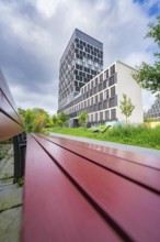 Modern building with tower block and park in the foreground, Munich, Germany