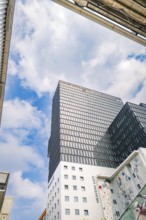 Towering modern high-rise under a blue sky with clouds, Werksviertel Munich, Munich, Germany