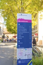 Urban signpost with distances to various destinations in a sunny neighbourhood, Sindelfingen,