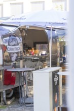 Curry snack van with open front, stainless steel look, shows interior design and menu,