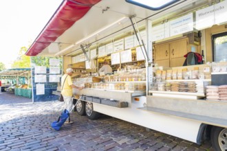 Person standing in front of a mobile market stall with various products, Sindelfingen, Böblingen