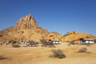 The isolated Spitzkoppe mountain (1728 m) provides a dramatic backdrop for the chalets of the