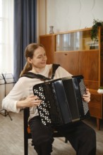 In a warm and inviting living room, a middle-aged woman skillfully plays the accordion, expressing