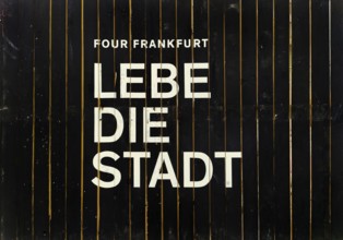 Construction fence in the banking district with the inscription Four Frankfurt Lebe die Stadt,