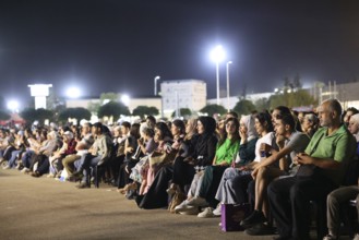 Audience members enjoy a musical performance during the Damascus International Fair in Damascus,