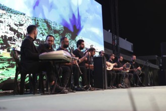 A Kurdish music group performs on stage during the Damascus International Fair, the first edition