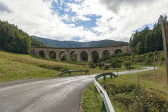 Adlitzgraben Viaduct, cloudy sky and green hills, Semmering Railway, Semmering, Lower Austria,