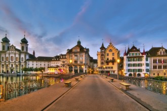 View of Lucerne's old town with Jesuit church from the Reuss bridge at dawn, Canton of Lucerne,