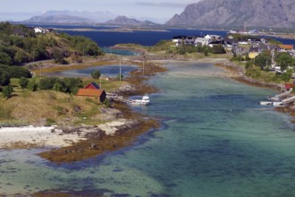 Coastal landscape with islands, clear waters and mountains in the background, Brönnöysund,