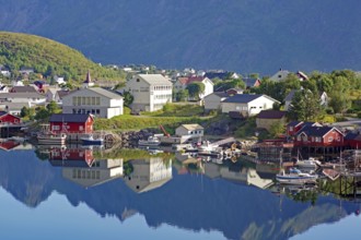 Small village with colourful houses and harbour facilities, picturesquely situated on the water,