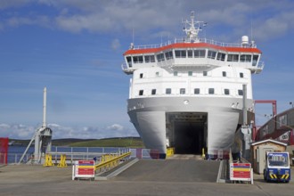 A large ferry is in the harbour ready for embarkation under a clear sky, Lerwick, Shetland Islands,