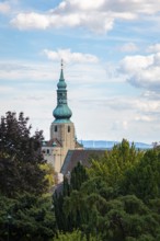 Church tower of St Stephan in Baden in front of a blue sky with clouds, Baden, Lower Austria,