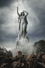 Undine Fountain with dramatic sky in the spa garden Baden, Lower Austria, Austria
