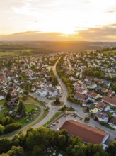 Residential neighbourhood with red roofs and winding streets at a gentle sunset, small town pearl