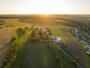 Sprawling fields and houses in a rural region at sunset, small town of Perle Calw, Black Forest,