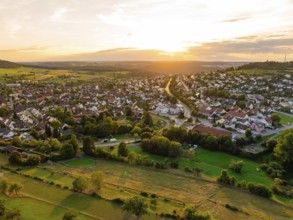 Spacious residential area with open fields and forests at sunset, small town of Perle Calw, Black