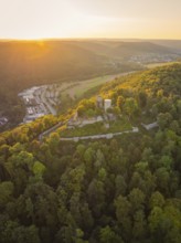Castle ruin on a wooded hill at sunset, surrounded by nature, small town Perle Nagold, Black