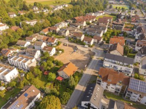 Quiet residential area with newly built area, surrounded by greenery and solar panels, small town