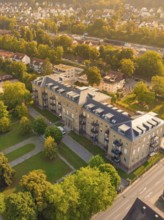 Large building with flat roof and balconies, surrounded by trees and streets in a sunny