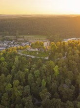 Castle ruins on a wooded hill at dusk, surrounded by dense nature, small town of Perle Nagold,